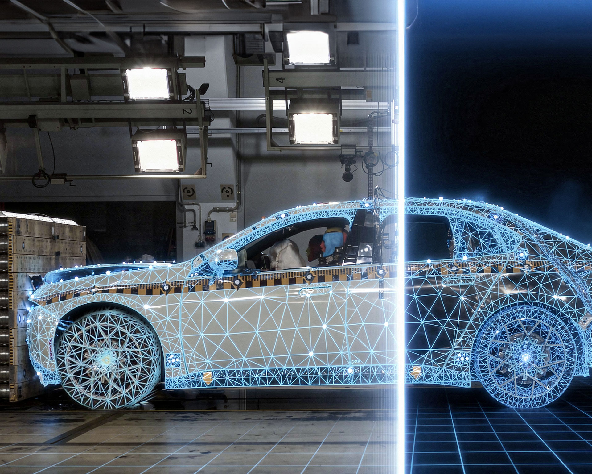 Photomontage showing a real crash test and a virtual simulation: On the left, the front of a BMW Group vehicle crashes in a test lab. On the right the rest of the vehicle is shown as a digital simulation.