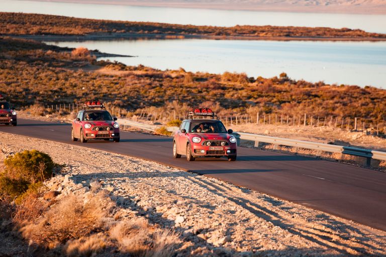 Three red MINIs on a desert road