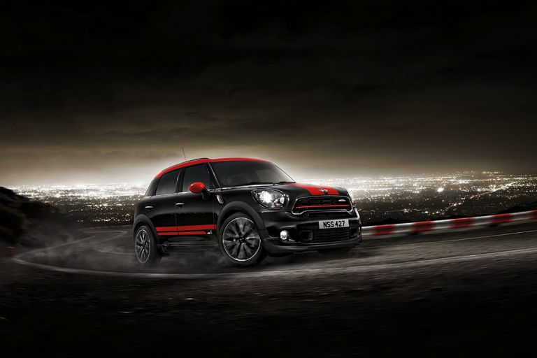 A MINI John Cooper Works Countryman driving up a mountain with skyline in the background.