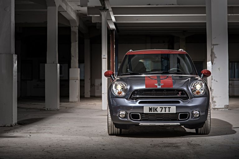 A MINI Cooper S standing in a space with concrete pillars.