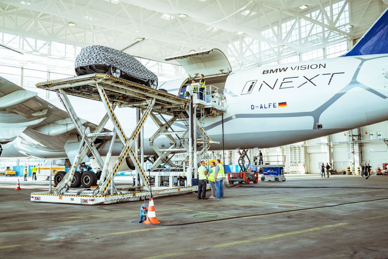 The BMW VISION iNEXT is loaded onto the aircraft.