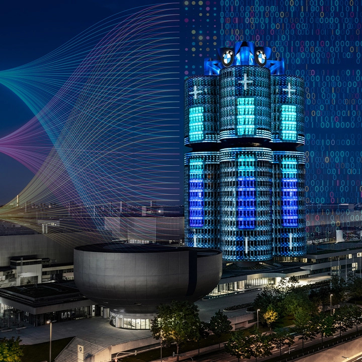 Der BMW Vierzyllinder, der in blauen Lichtern erstrahlt, vermittelt ein futuristisches und elegantes Stadtbild.