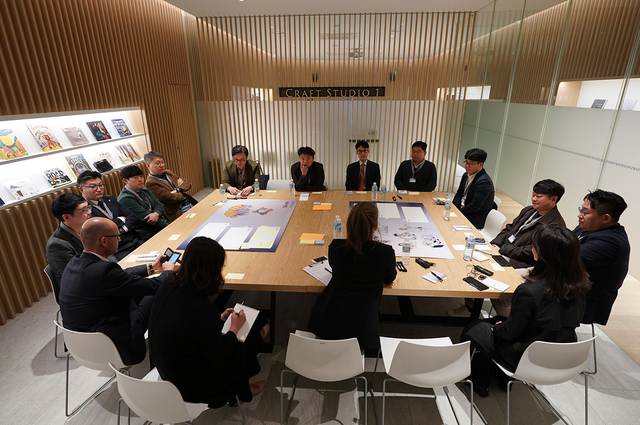 People are sitting at a conference table