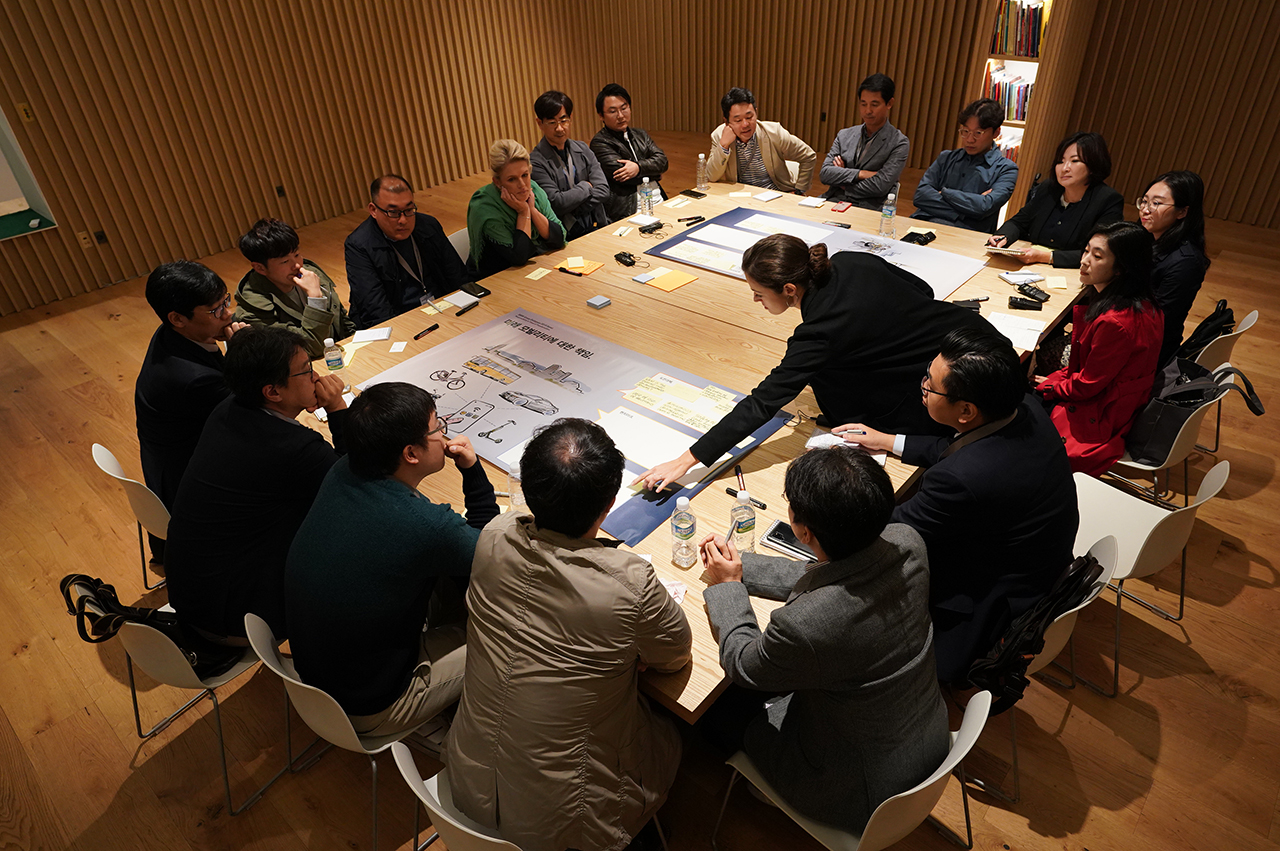 People are sitting at a conference table