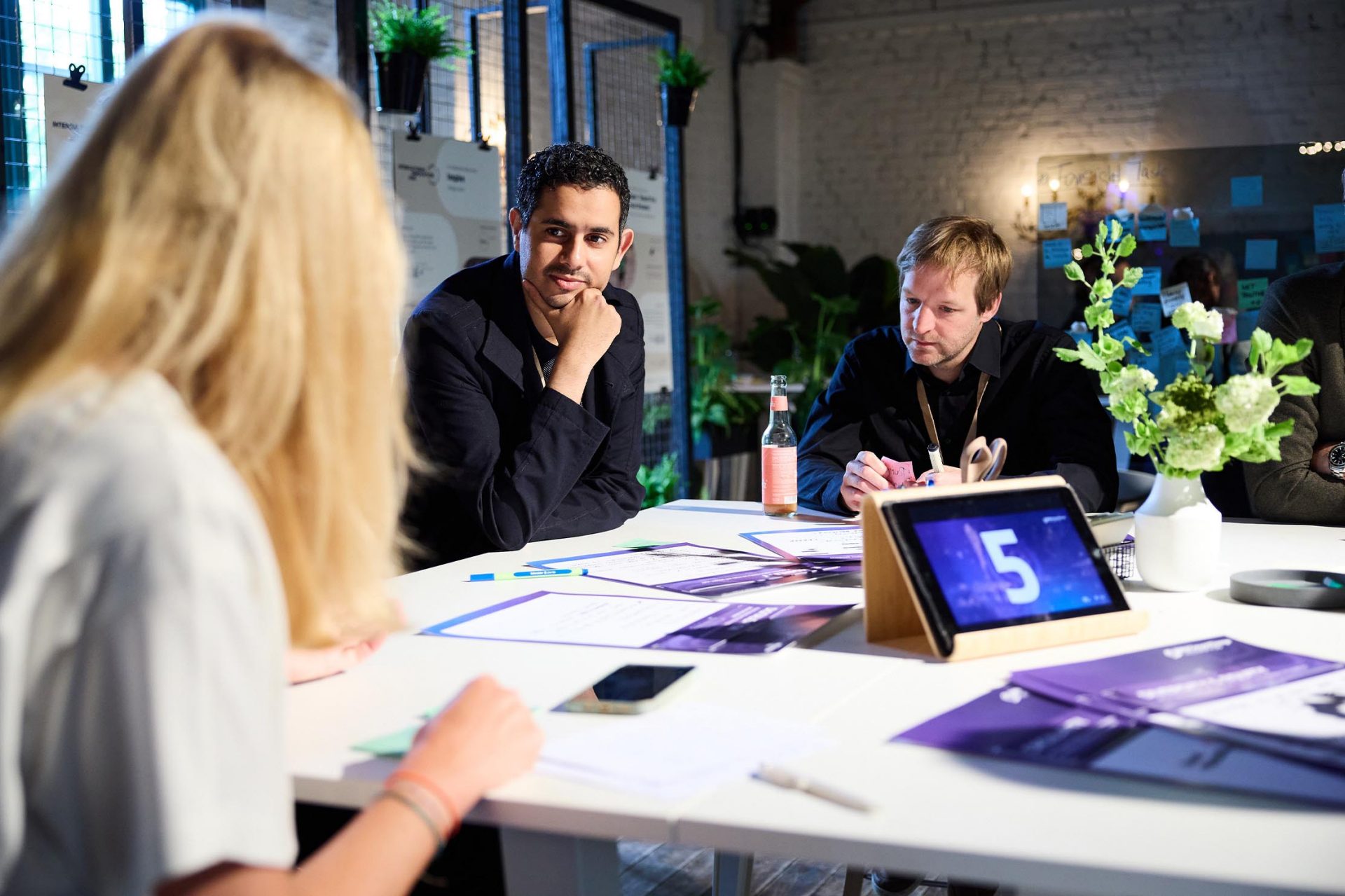   A team gathered around a table discussing innovative ideas.