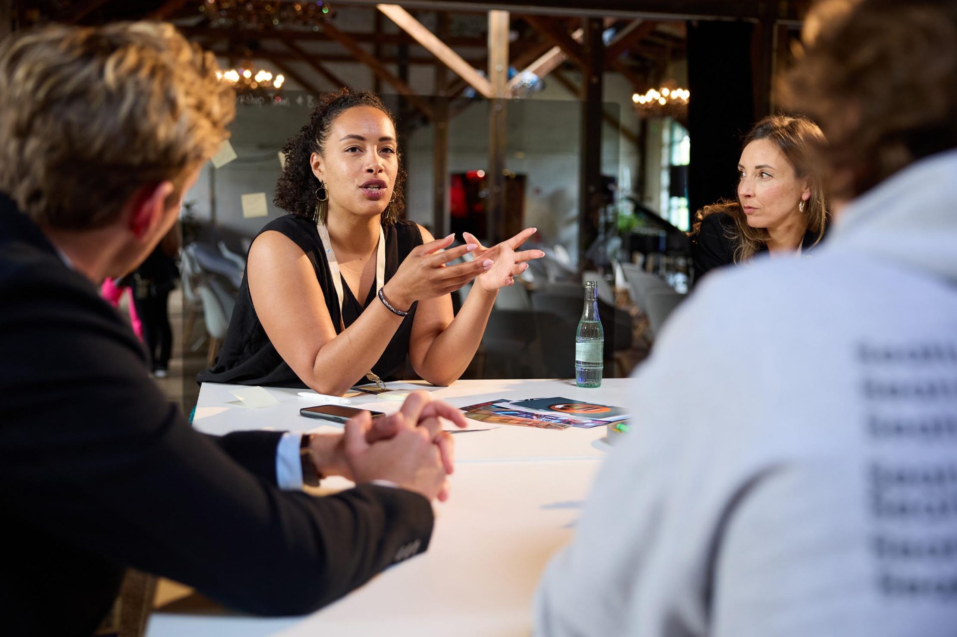   Women are engaged in a lively discussion during a meeting.