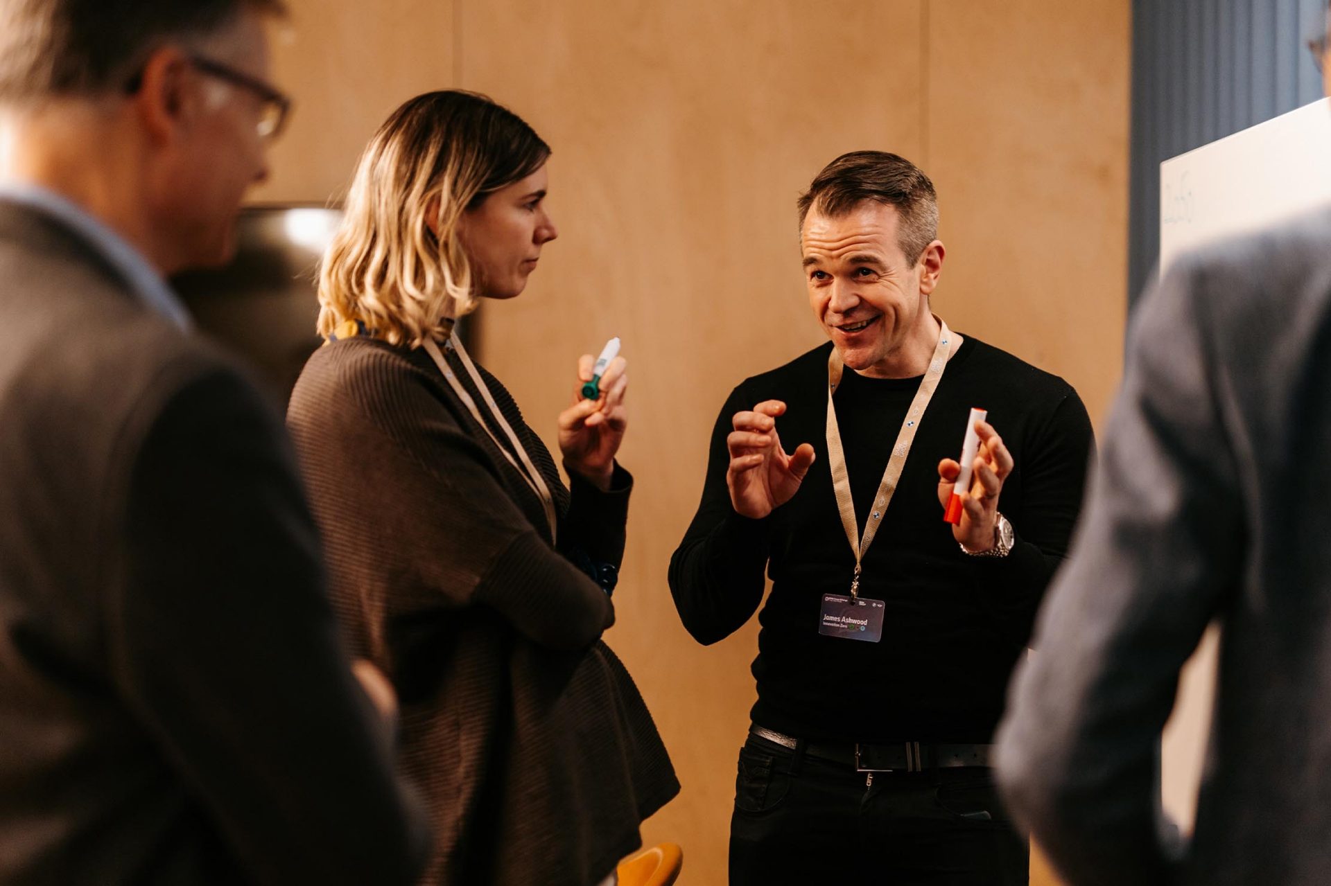 A man is talking to two people