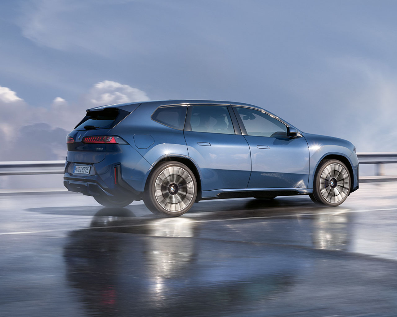 BMW Neue Klasse electric concept car with modern design driving on a road.