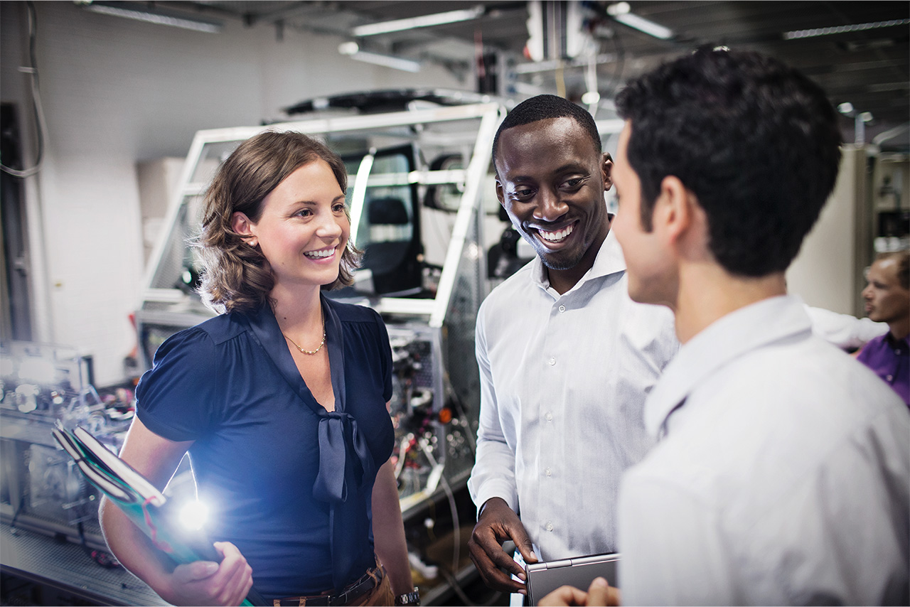 A group of professionals discussing ideas in a modern workspace.
