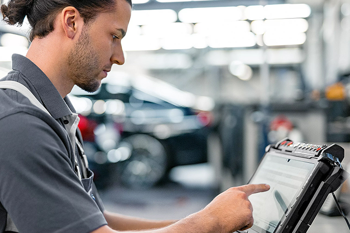 BMW workshop employee with a tablet