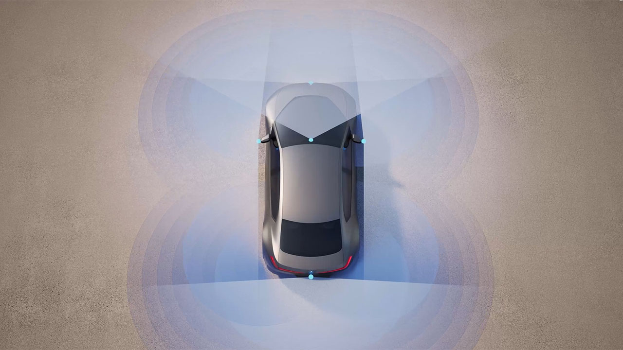 Top view of a gray car with visible sensor beams in different directions.