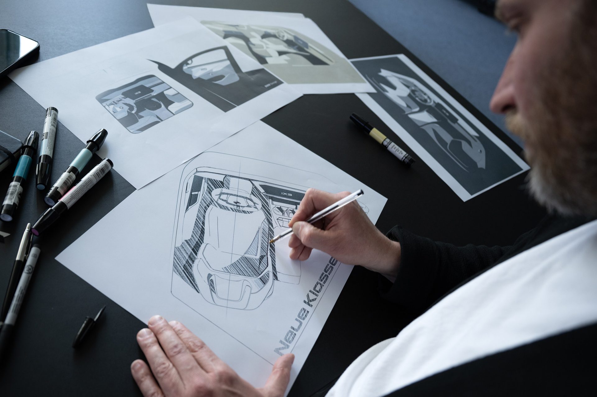 A BMW Group designer sketches the interior of a new vehicle.