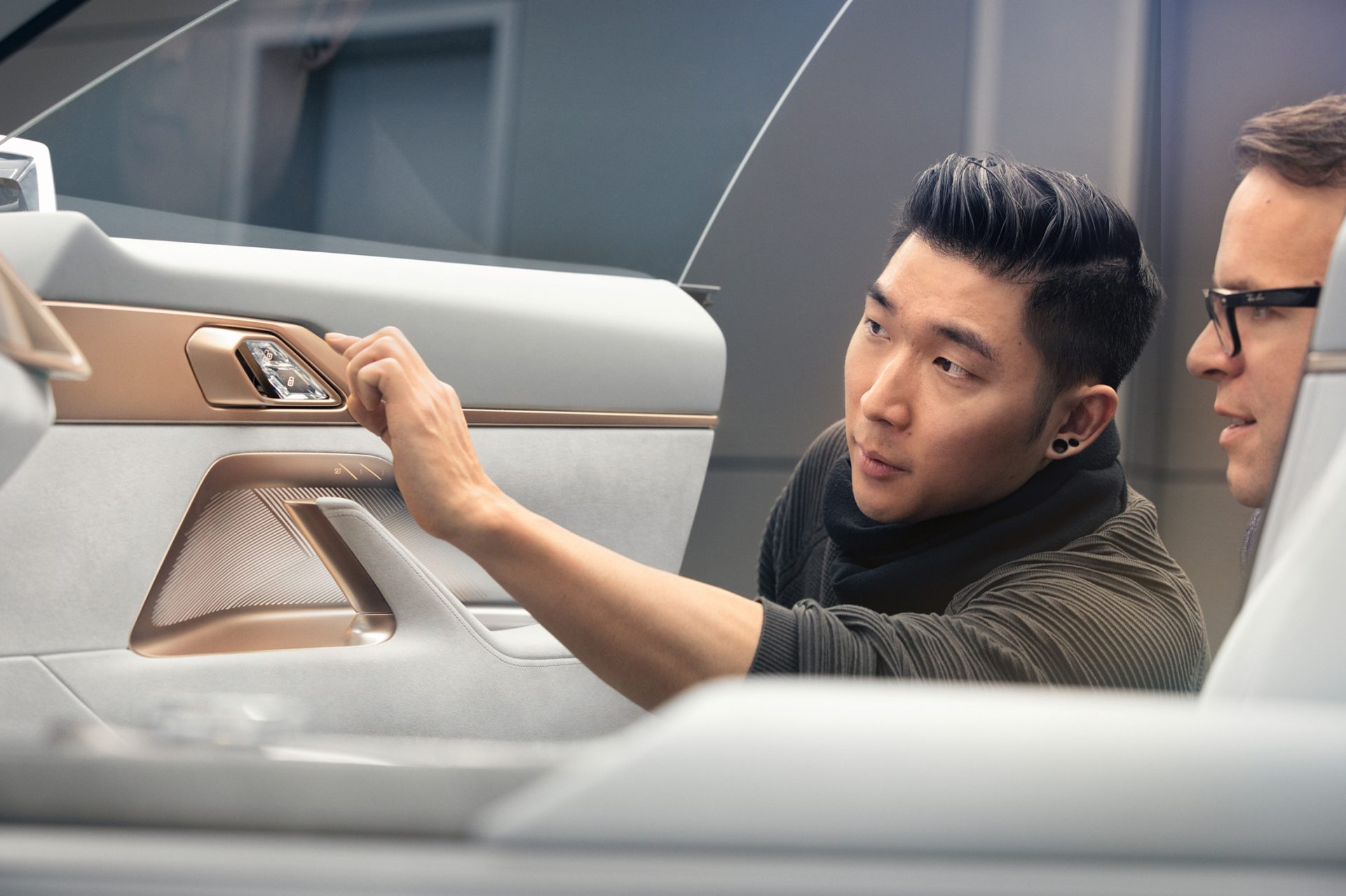 Two Designers are inspecting the interior on a vision vehicle