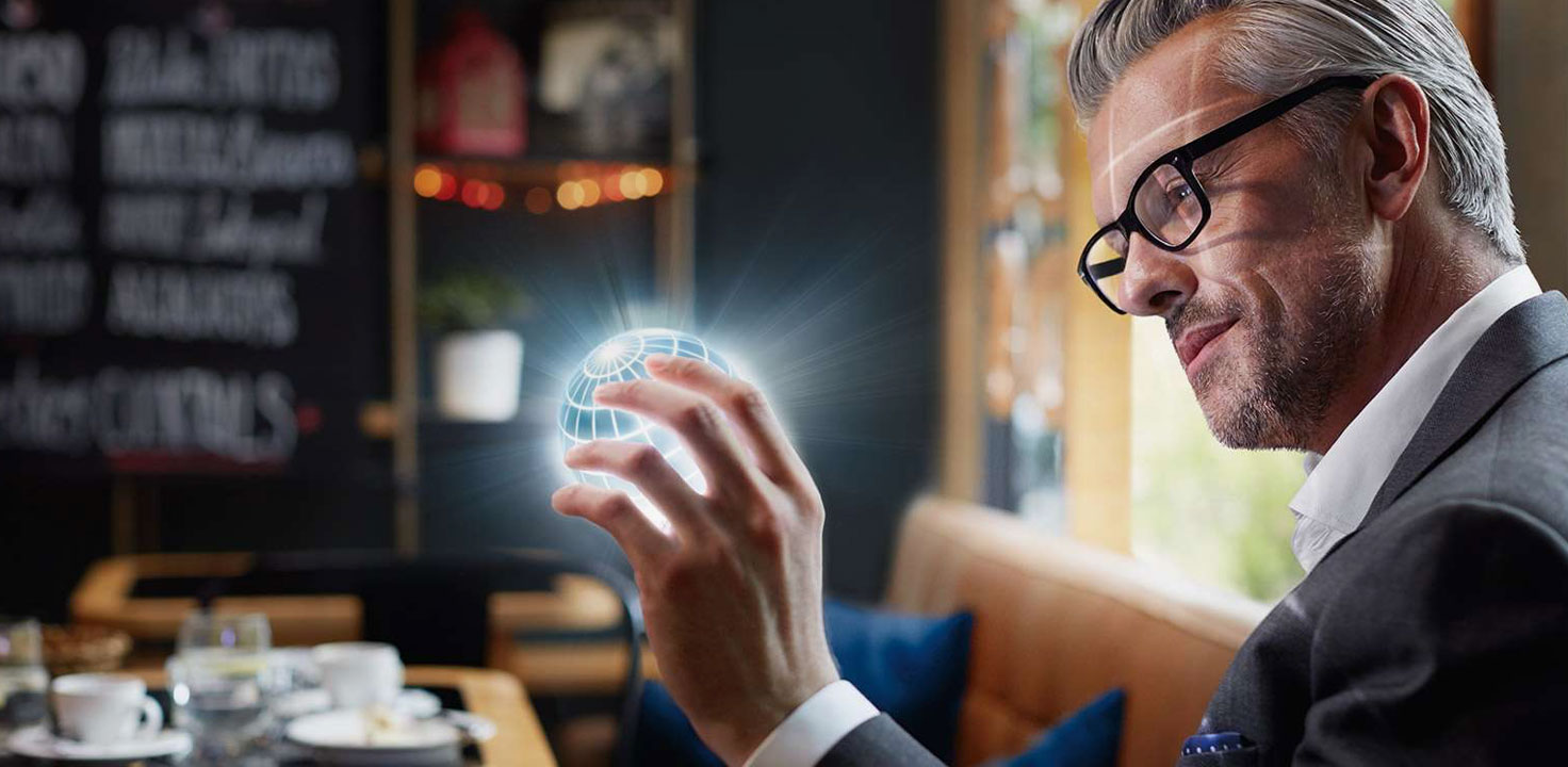 Man holding a globe in his hands.
