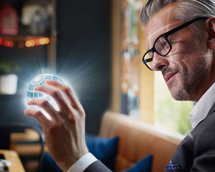Man holding a globe in his hands.