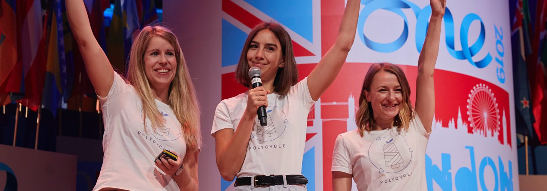 Three women of the Polycycle team on a stage