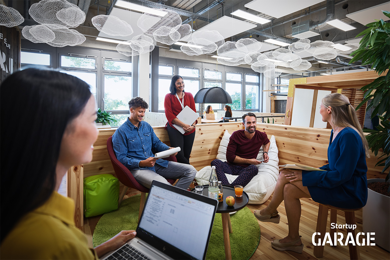  A group of five people are having a cheerful discussion.