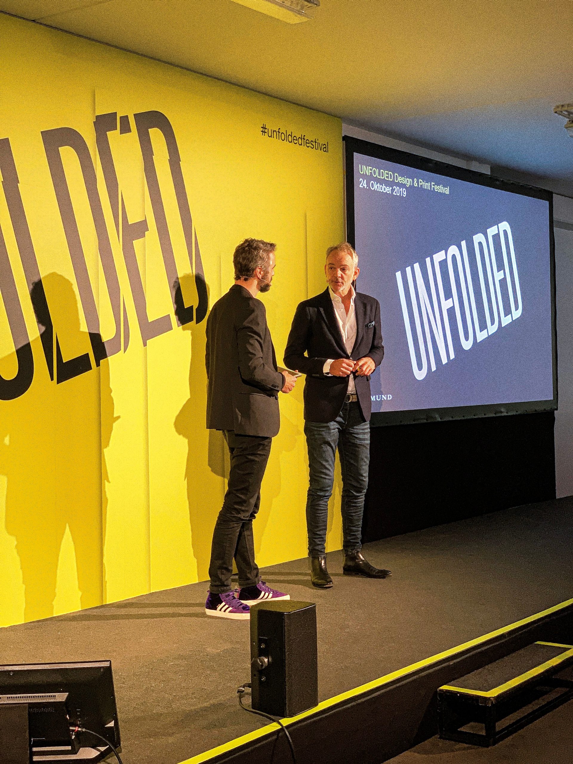 Adrian van Hooydonk with moderator on stage