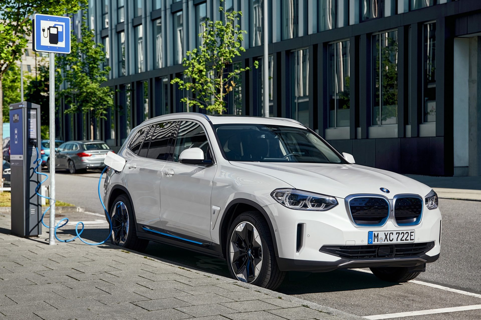 The BMW iX3 in front of a charging station