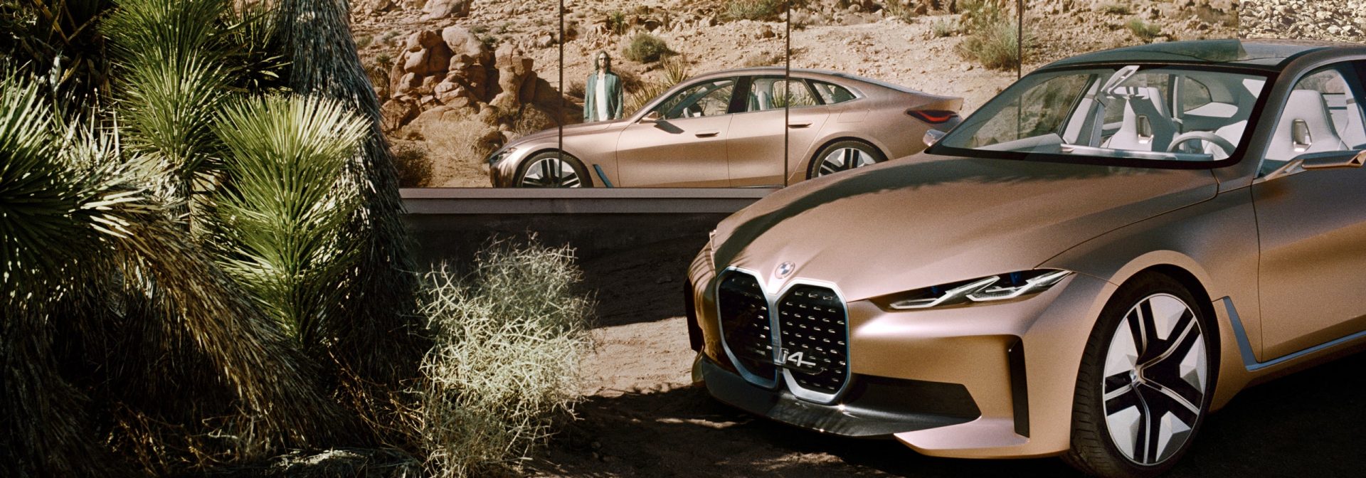 The BMW Concept i4 in a landscape in front of mirrors