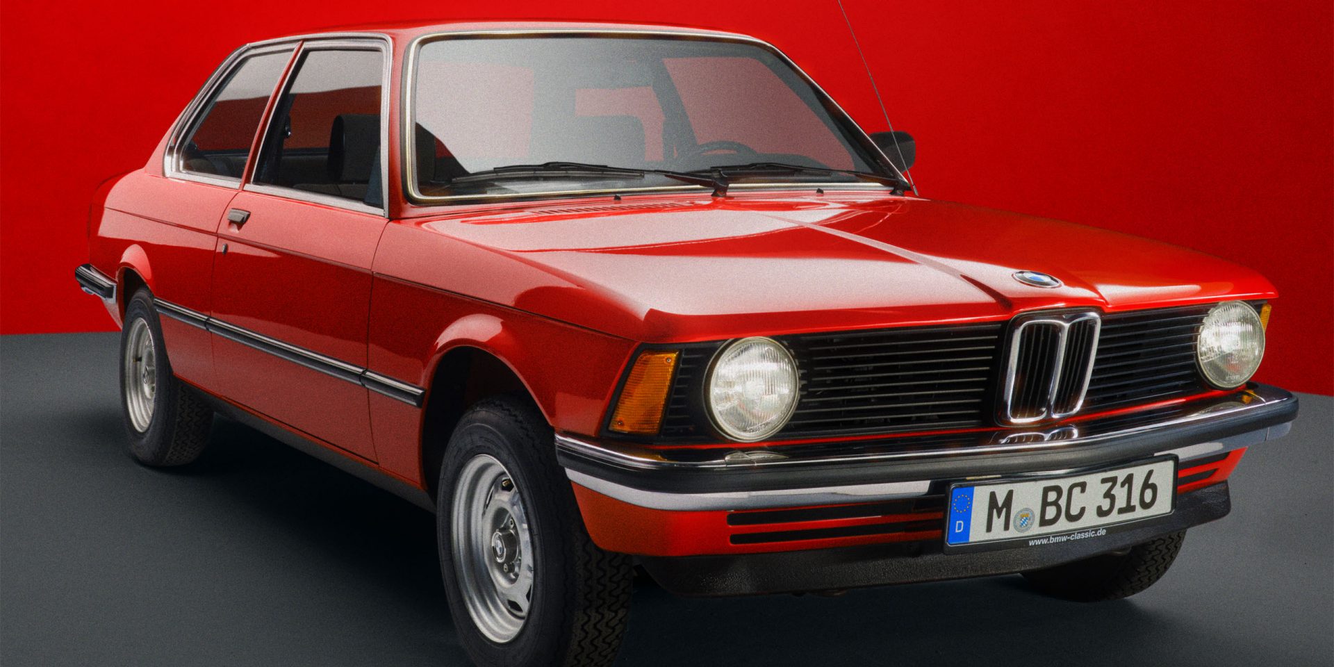 A red BMW E21 seen from the front right.