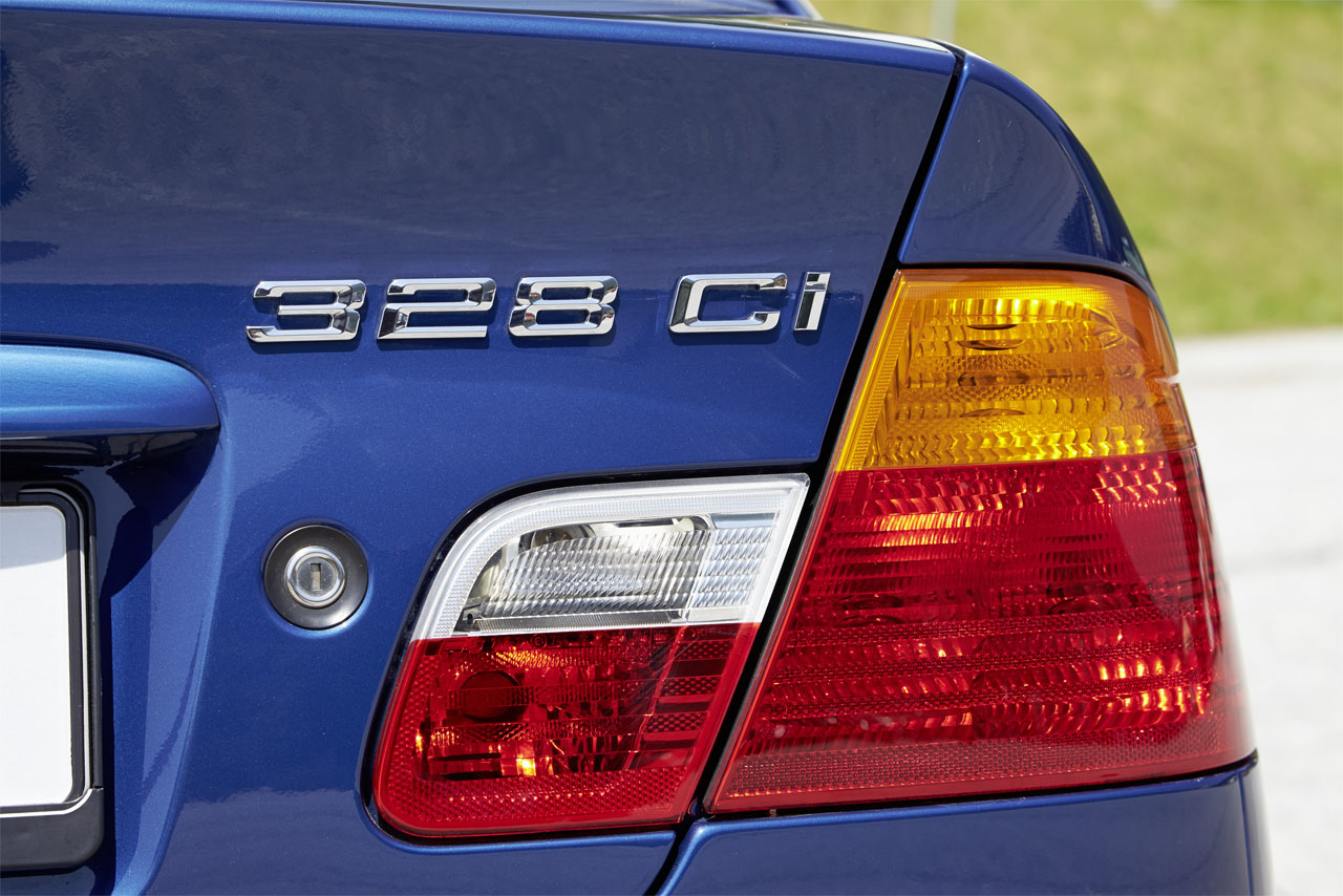 Closeup of the characteristic L-shaped tail lights of a blue BMW E46 (328 Ci).