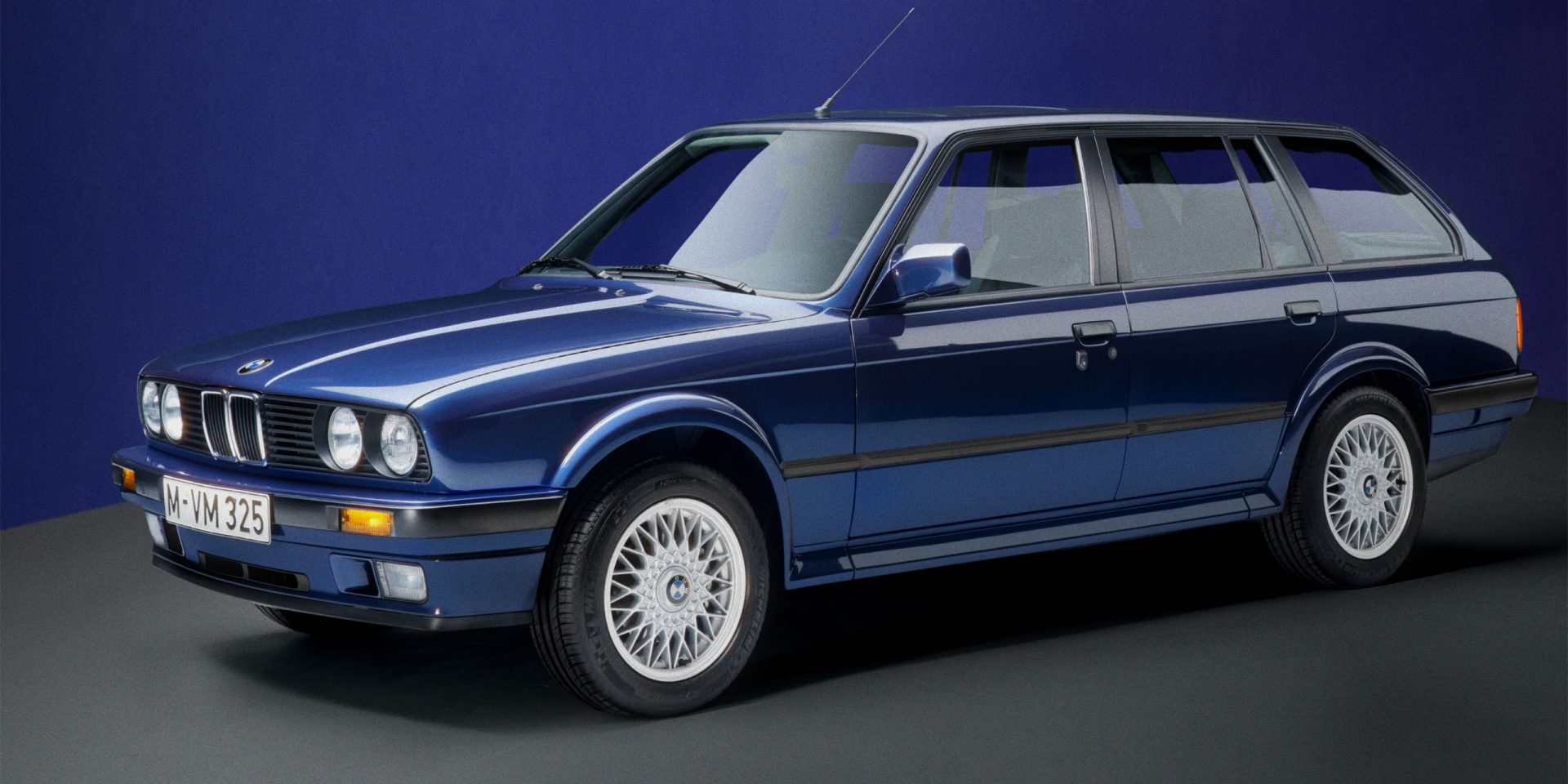 Classic hatchback: The front and side of a dark blue BMW E30 Touring