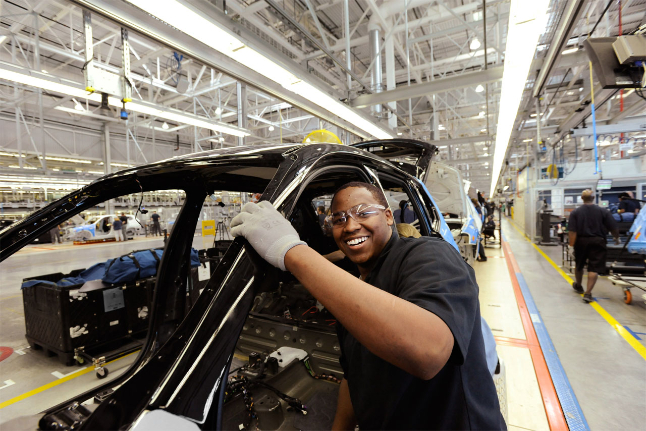 An employee smiles as he works on the production line at BMW Group Plant Spartanburg, South Carolina.