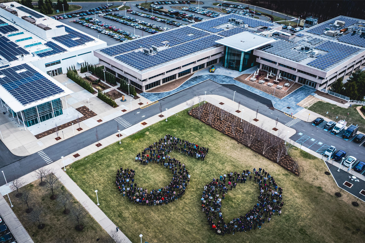 Aerial view of BMW of North America’s new headquarters: Employees form a huge 50 outside on the lawn.