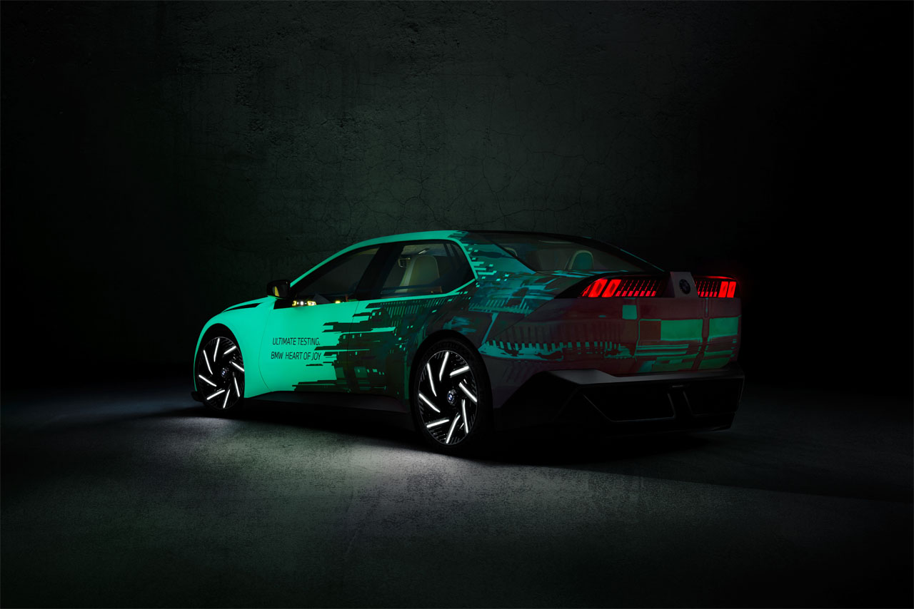 A BMW Vision Driving Experience in a dark space illuminated by green light.