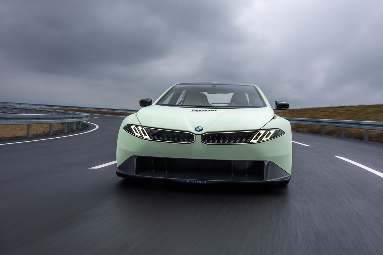 Front view of the BMW Vision Driving Experience as it drives dynamically on the test track.
