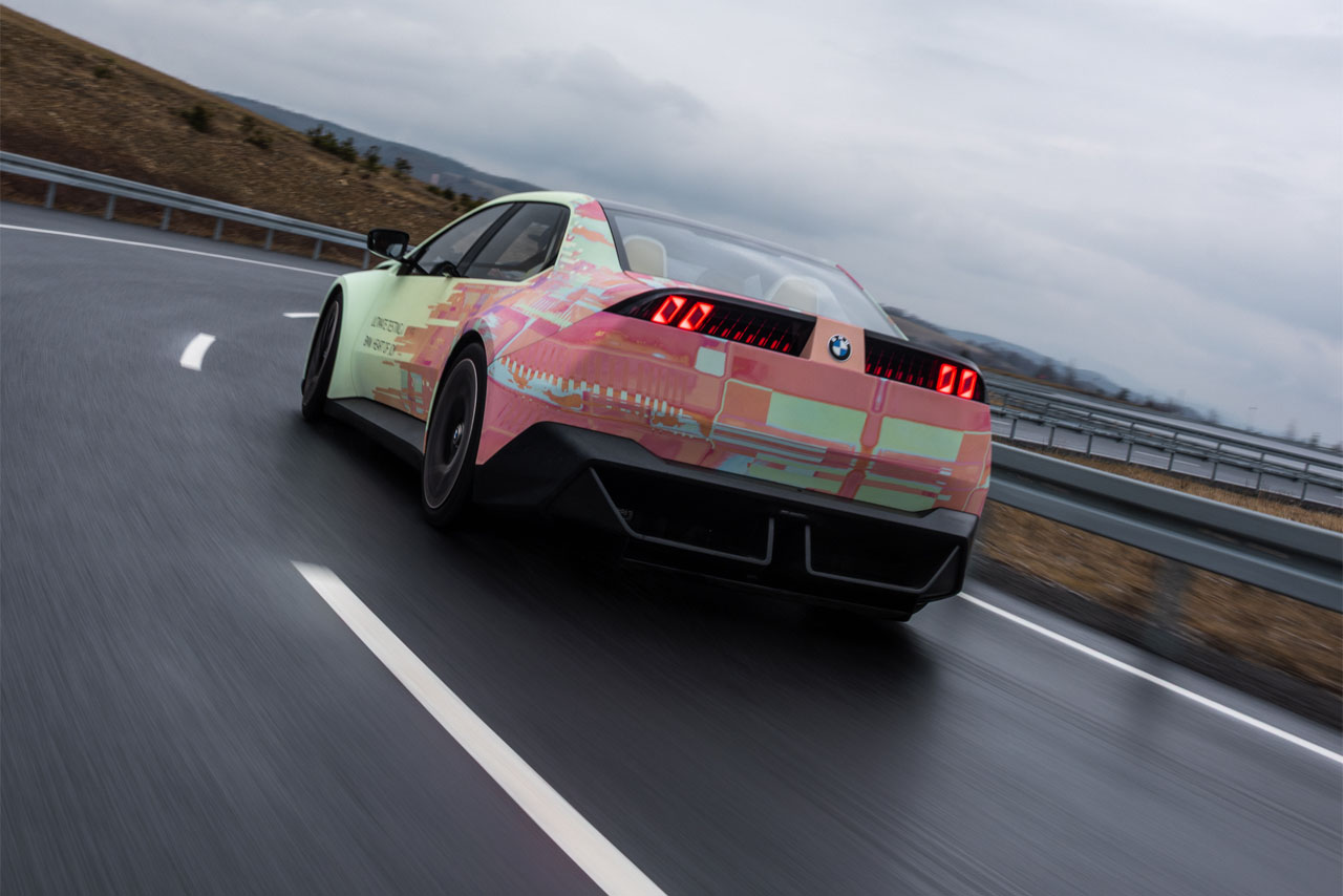 Rear view of the driver’s side of the BMW Vision Driving Experience as it brakes to enter a bend.