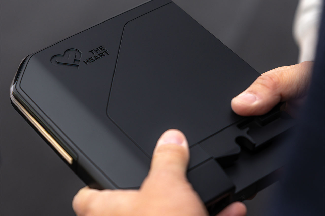 Heart of Joy: A BMW Group employee holds the black box of the control computer.