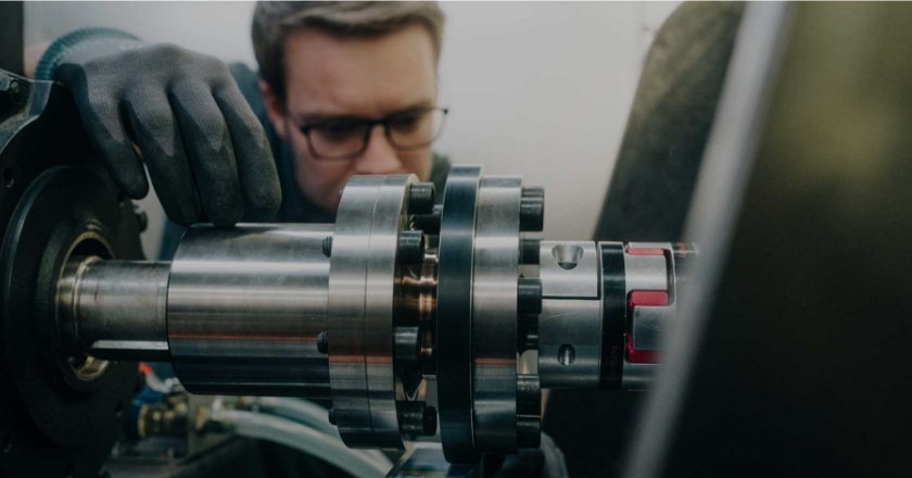 Focus on a man installing a component in a car.