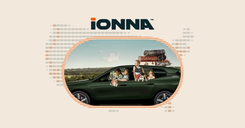 A family is travelling in a car with a full luggage rack. The IONNA logo is above it.