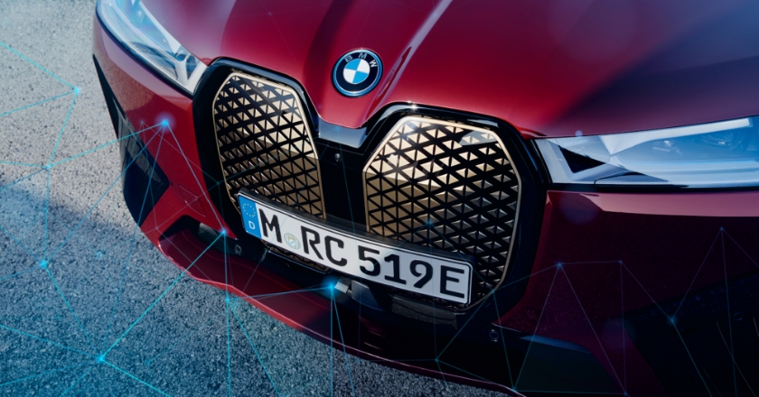The rear of a red BMW surrounded by a network of blue lines and dots.