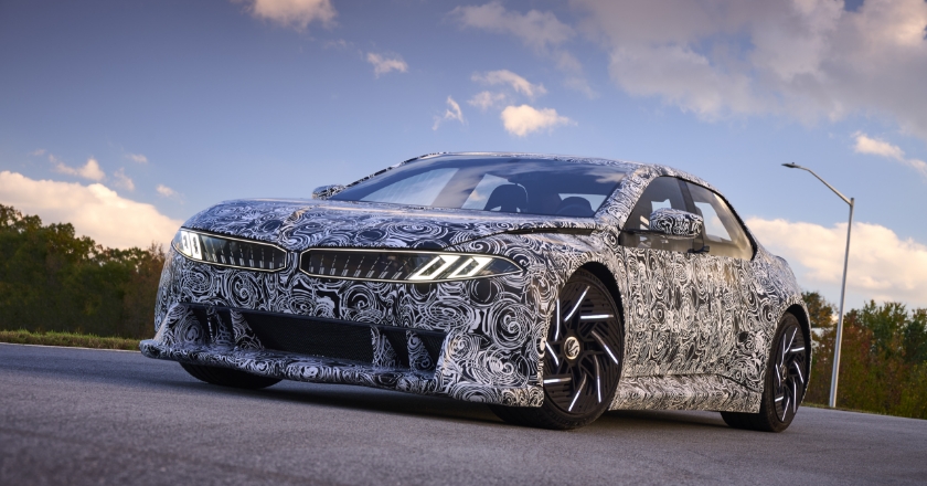 A BMW with camouflage foil stops on a test track.