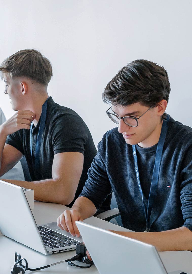 Several people working on laptops together.