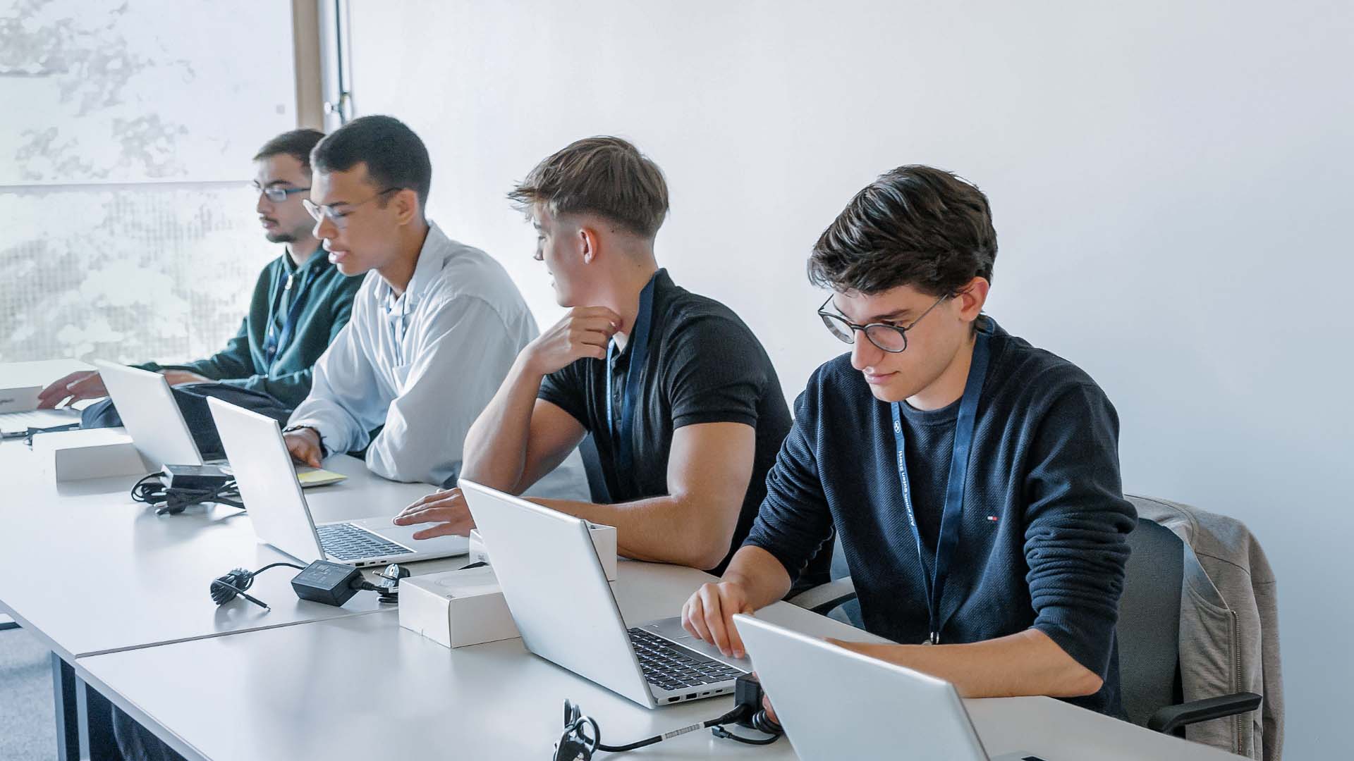 Several people working on laptops together.