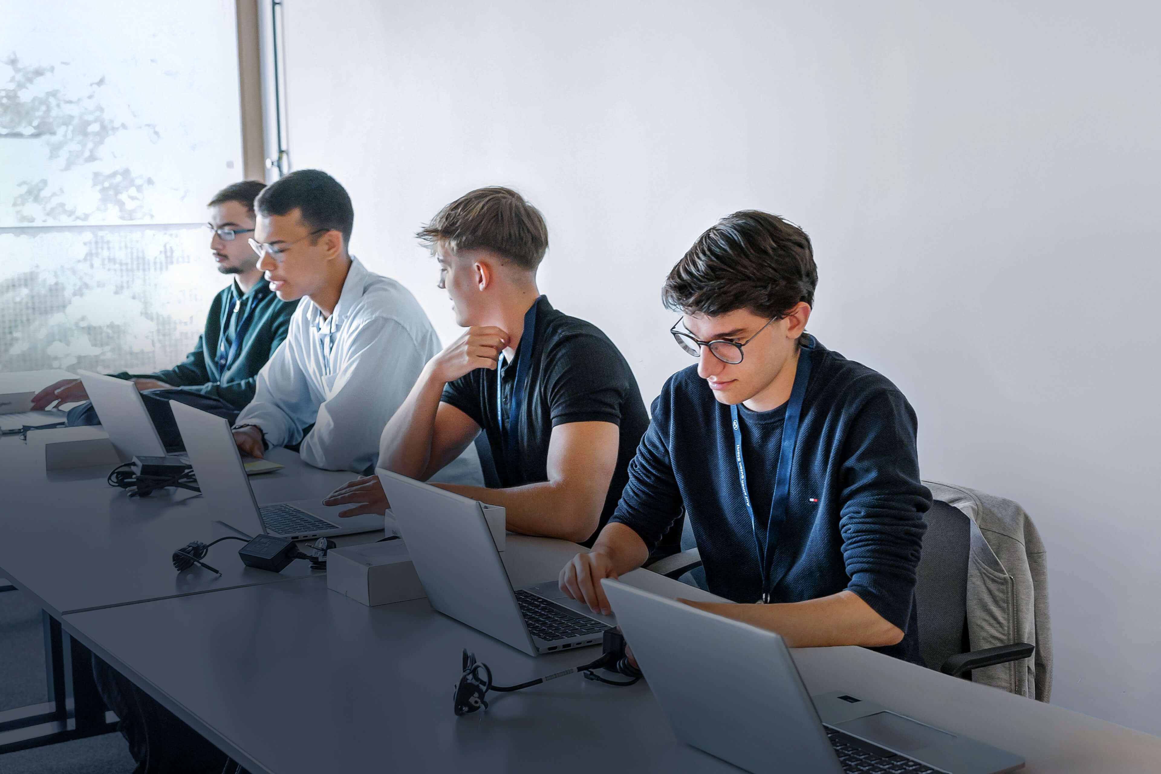 Several people working on laptops together.