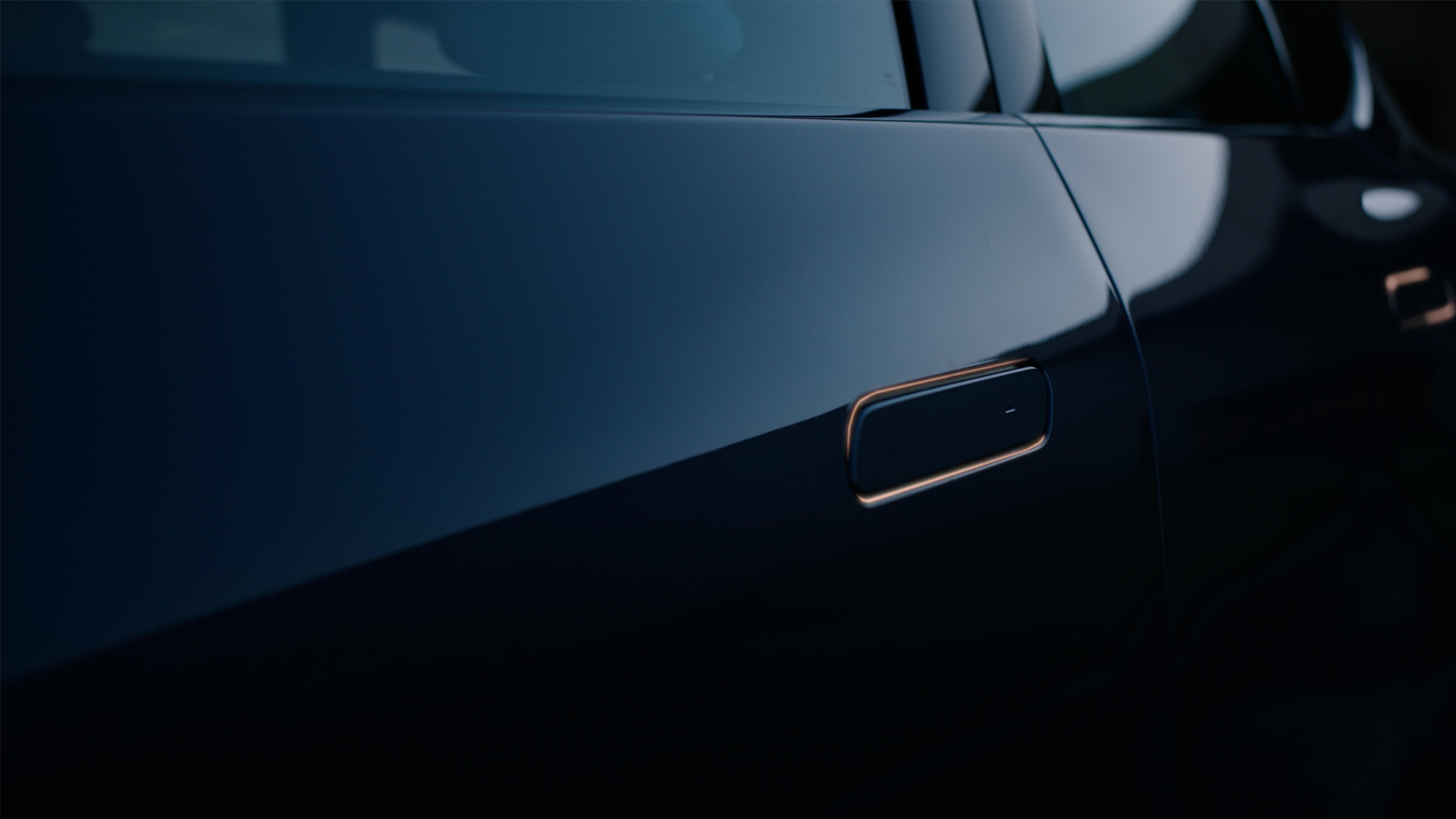 Detail of the side panel of a BMW model with a flush‑integrated door handle.