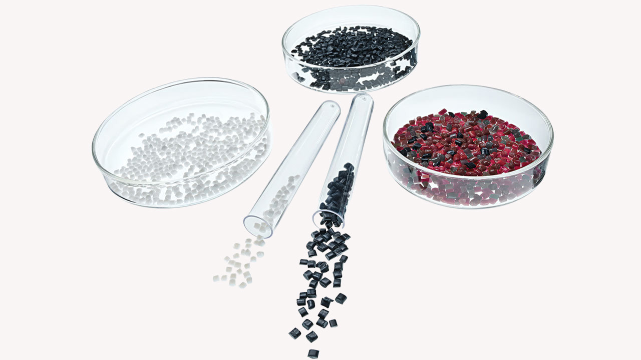 Three glass bowls with different colored seeds arranged on a neutral background.