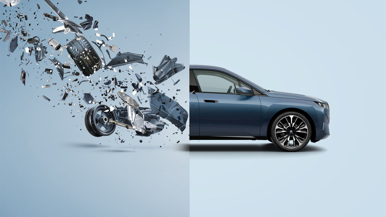 A blue car with a broken windshield and a damaged door.