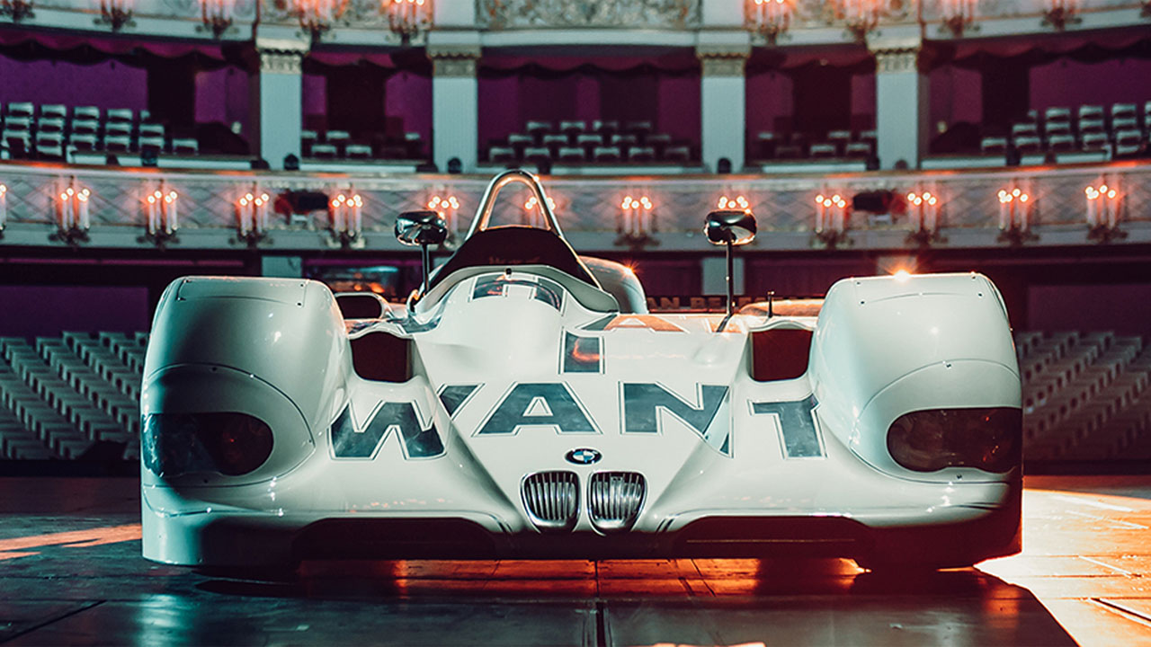 A vehicle is parked in front of an imposing stage set up for a performance.