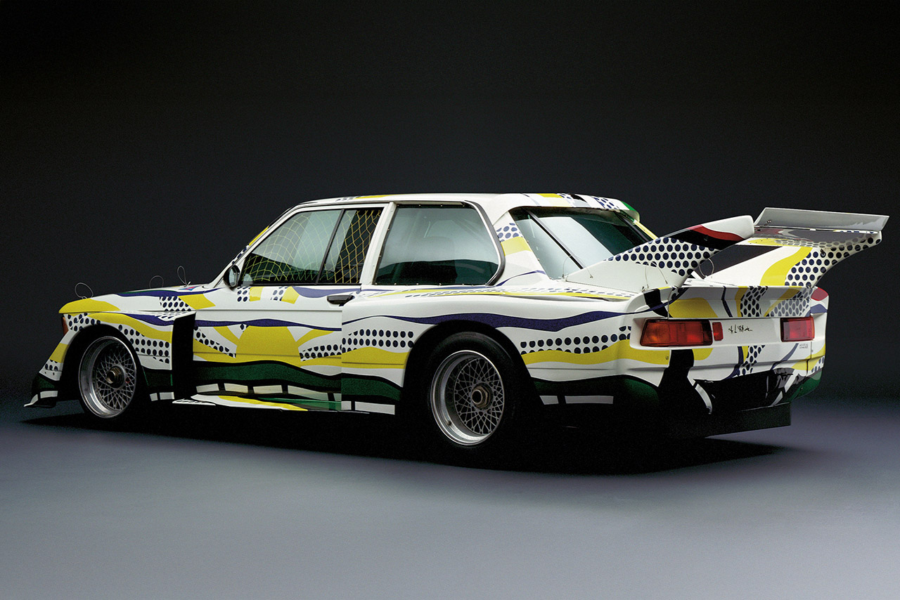 Side view of a vintage 320i with vibrant colors and abstract patterns.