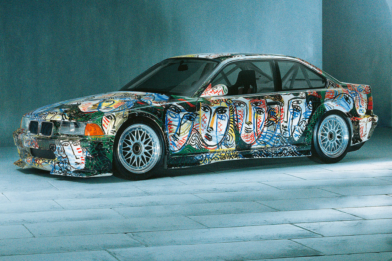 A colorful BMW M3 GTR adorned with vibrant graffiti art.
